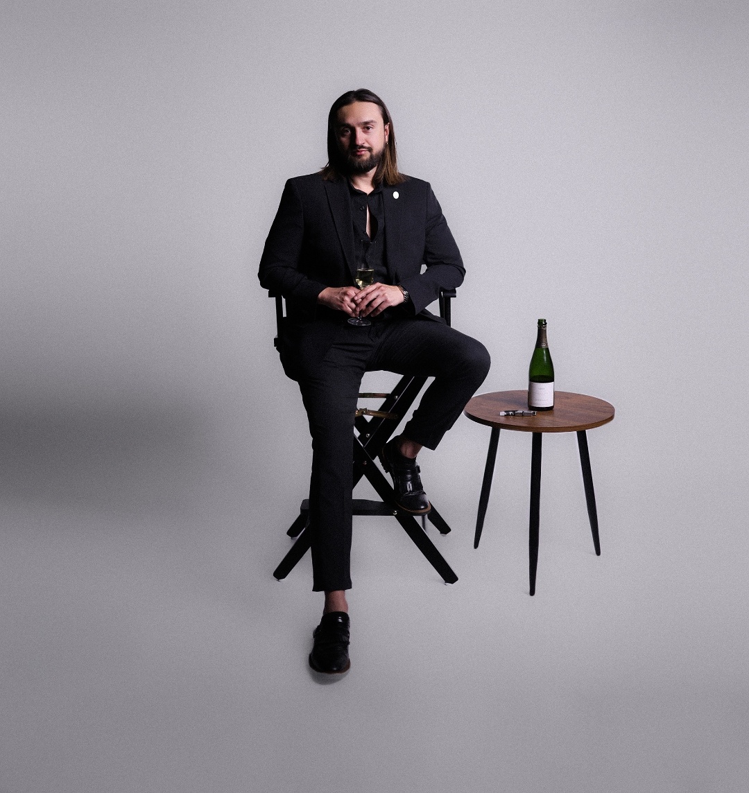 Nico Antuna Cooper, Certified Sommelier, with a glass of Champagne