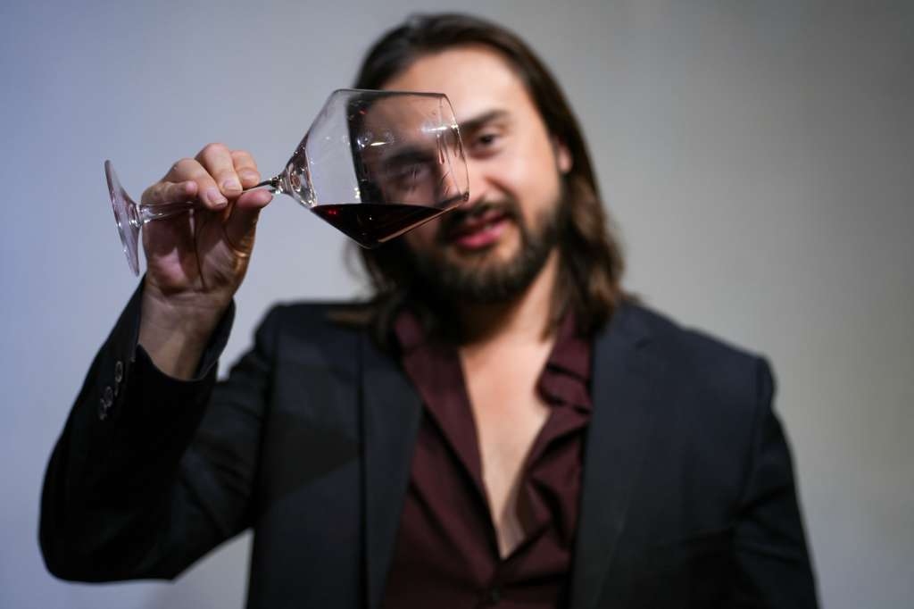 Nico Antuna Cooper inspecting wine in glass